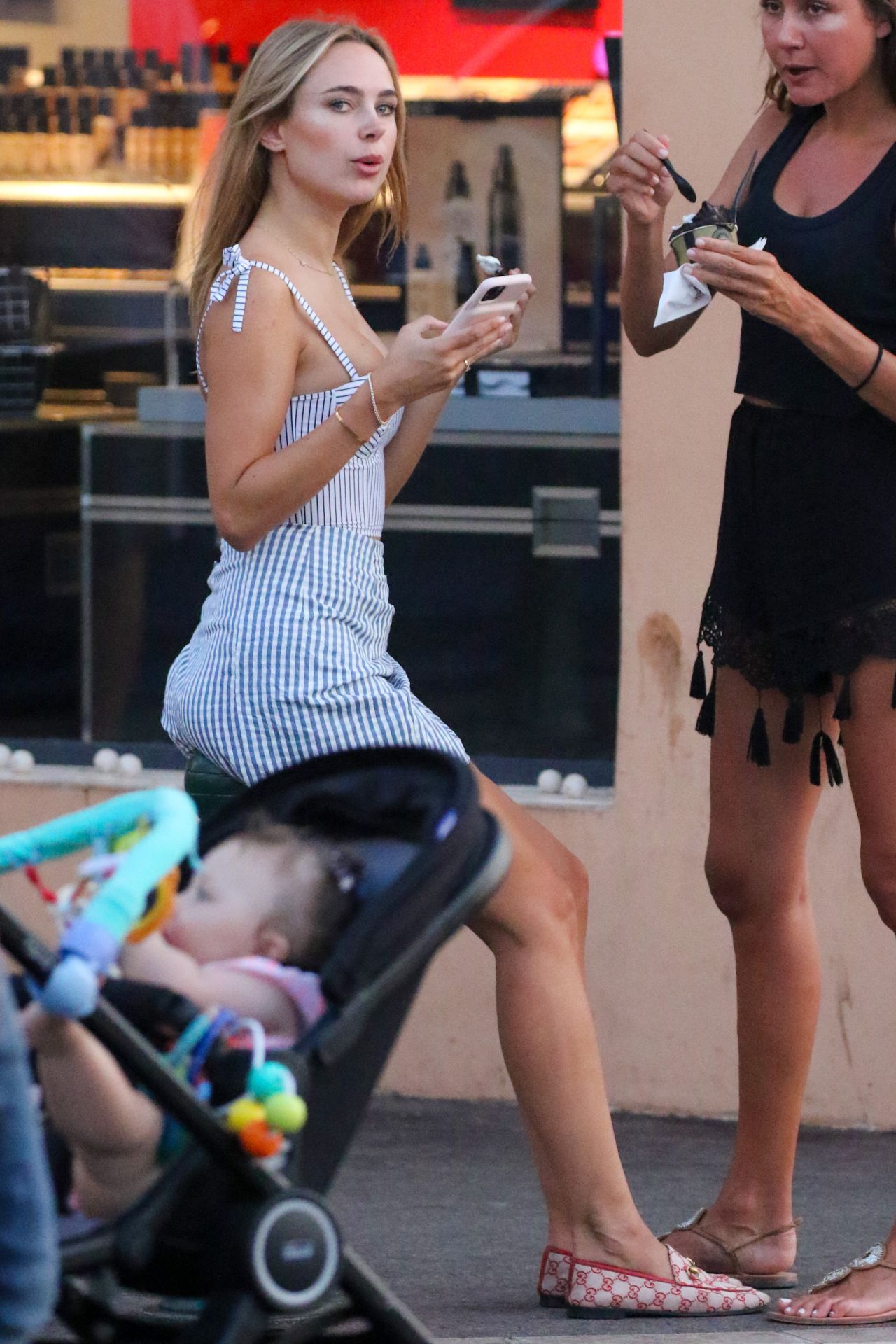 kimberley-garner-in-check-mini-skirt-and-bustier-top-eating-ice-cream-in-saint-tropez-07-29-20...jpg